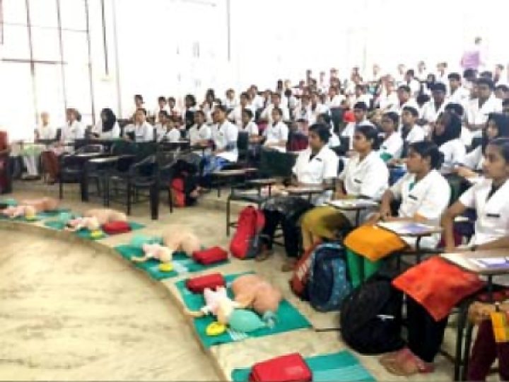 Large group of nursing students with CPR manikins in front of them